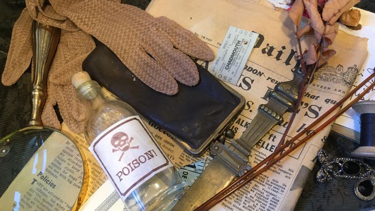 Crime scene with poison bottle, gloves, magnifying glass, dagger, newspaper, and dried rose arranged on a table.