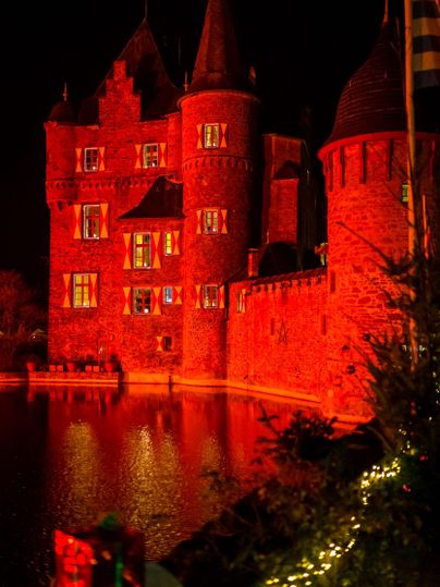 Red illuminated Castle Satzvey