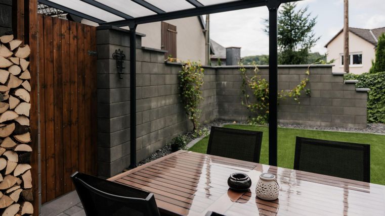 Geschützt draußen sitzen und grillen, auch bei Regenwetter möglich. Links befindet sich das Kaminholz für den Holzofen im Wohnzimmer.