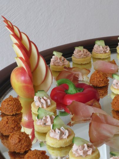 An appetizing buffet with various snacks and finger foods. The colorful treats are artistically arranged and include fresh vegetables and fruit.