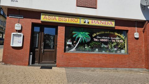 An Asian bistro named "Panda". The windows are decorated with a palm motif and there is a phone number for orders.