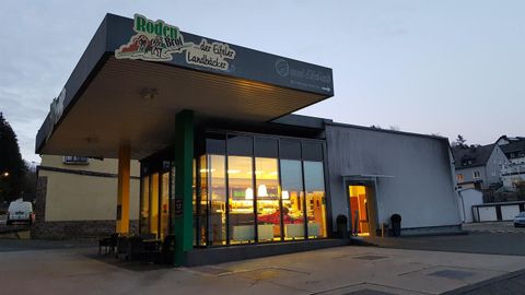 A modern restaurant with large windows and an inviting entrance. The facade is brightly lit and appears welcoming.