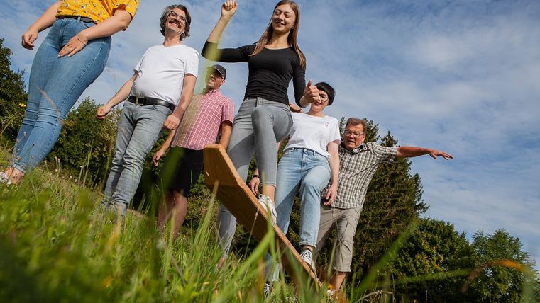 Children balancing on a meadow