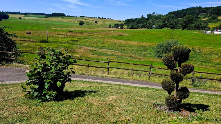In front of the house with a view of the valley
