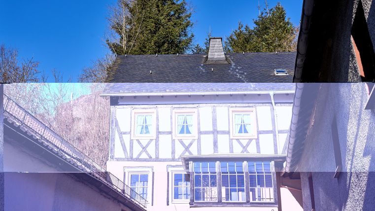 A charming half-timbered house with a clear blue sky.
Surrounded by trees and a peaceful ambiance.