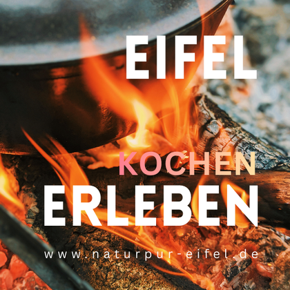 A cooking pot over an open fire in nature. Experience the Eifel with delicious outdoor cooking.