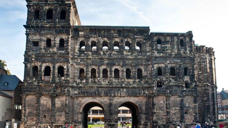 A historic building with impressive architecture. Many people visit the ruins.