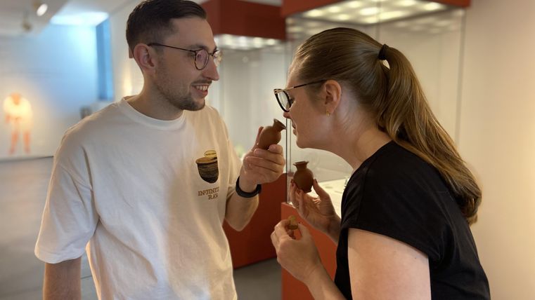 Two people are taking a scent sample in the exhibition.