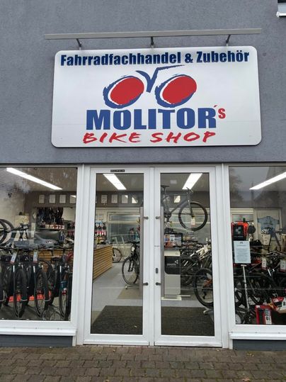 A bike shop with the label "Molitors Bike Shop". Bicycles and accessories are visible.
