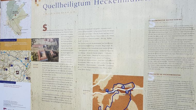 An information board about the spring sanctuary Heckenmünster. It contains maps and texts about the history and the paths in the surrounding area.