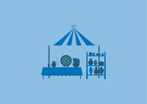 A stand with pots and dishes under a blue tent. In the background, there is a shelf with more pots and decorations.