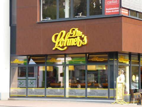 A shop named "Löhner's" with yellow lettering on the facade. The windows are invitingly designed and showcase various products.