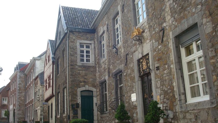 A picturesque street with historic stone walls and charming windows. The cobbled street invites you to stroll.