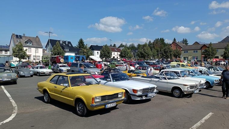 In een rij opgesteld oldtimers in verschillende kleuren geel, wit, blauw
