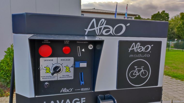 A bicycle washing machine with various controls. It offers an easy way to clean bicycles outdoors.